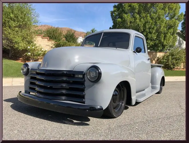 Vintage gray pickup truck on sunny day