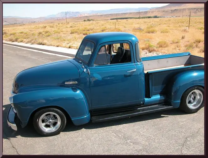 Classic truck parked on sunny road