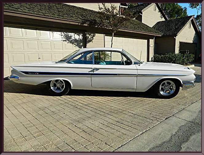 Classic white vintage car parked outside