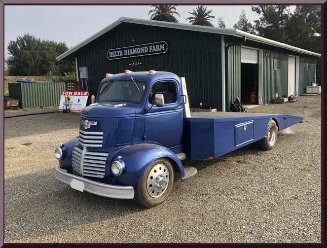 Classic truck near green barn