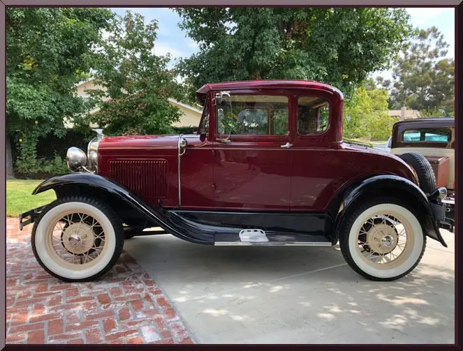 Vintage red classic car in driveway