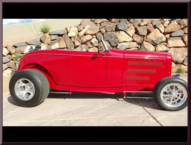 Classic red hot rod in sunlight.
