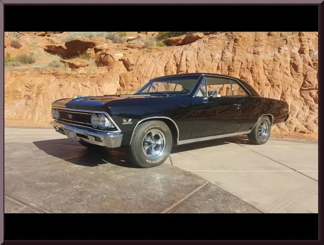 Classic black car on desert road