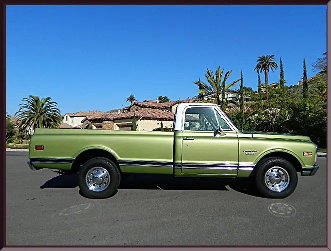 Green vintage pickup truck in suburban area