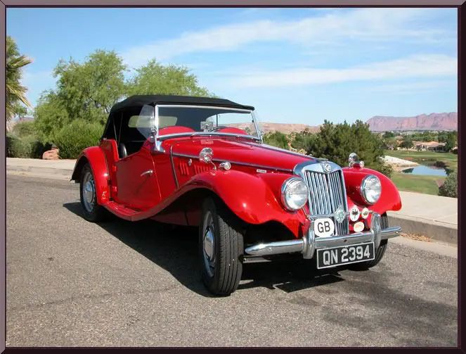 Red vintage car on sunny road
