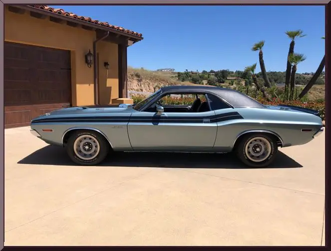 Vintage car with black roof and wheels.