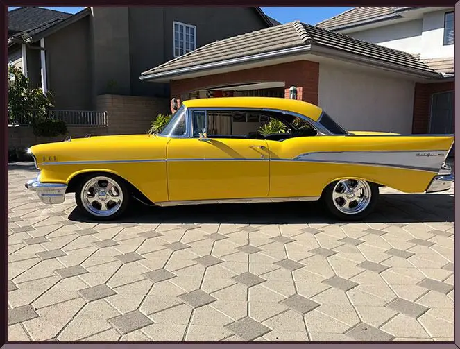 Retro yellow car on tiled driveway