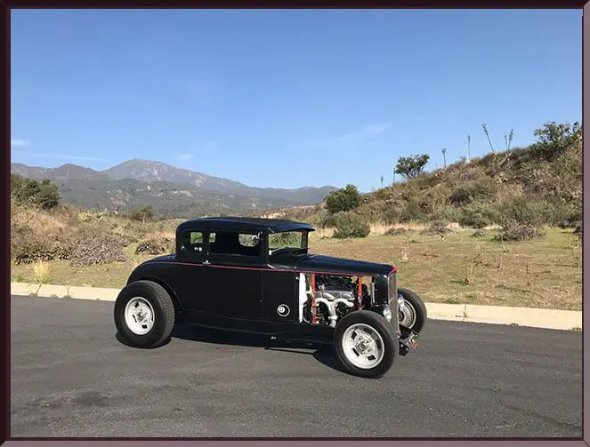 Classic car with scenic mountain backdrop