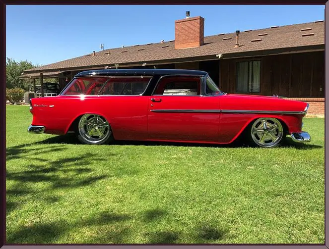 Red classic car parked on grass