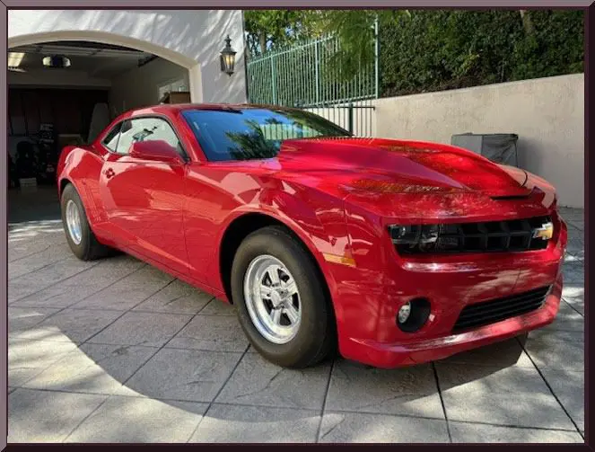 Red sports car parked on driveway