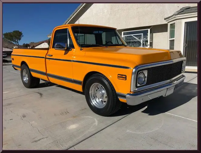 Vintage yellow pickup on driveway