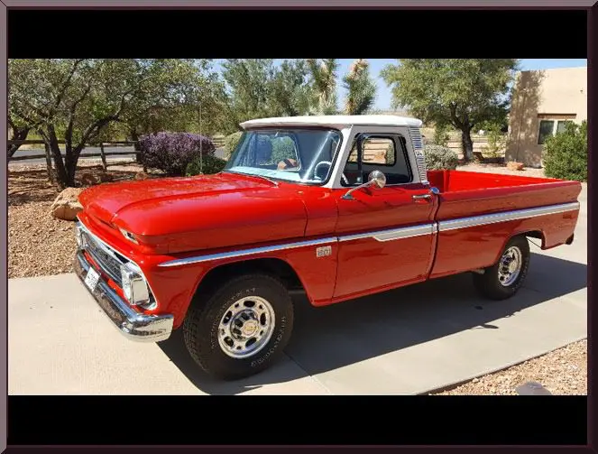 Classic red pickup truck parked in driveway