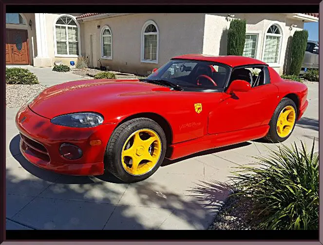 Classic red car parked in driveway