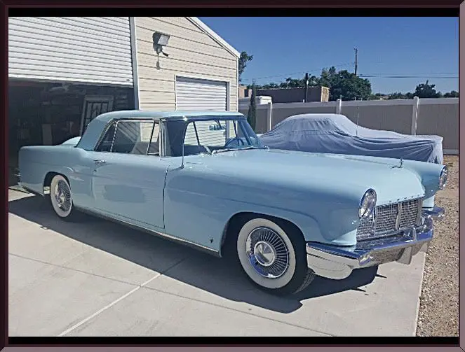 Vintage blue car parked in driveway