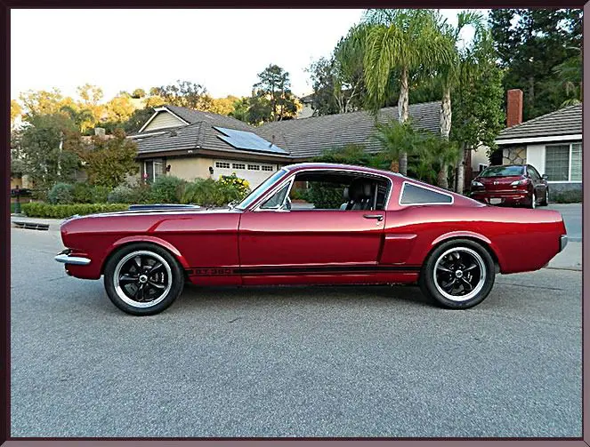 Iconic red sports car beside houses