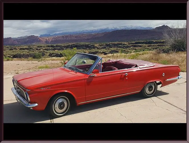 Red vintage convertible on desert road