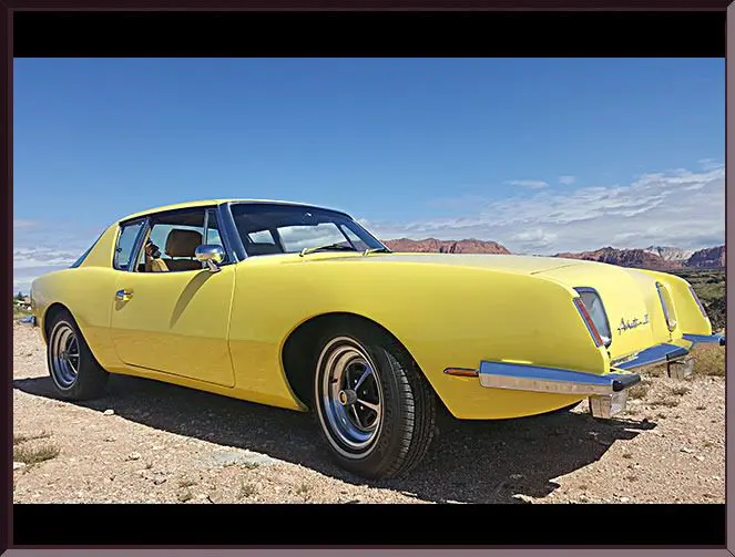 Yellow vintage car parked in desert