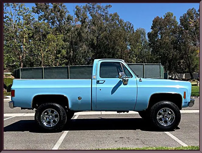 Blue vintage pickup truck in parking lot