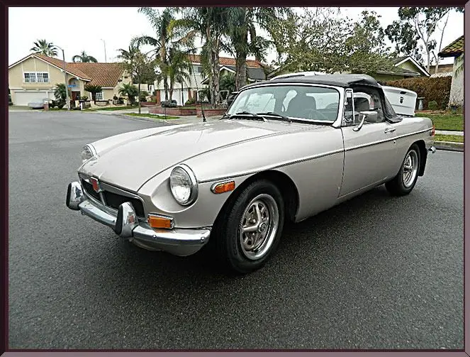 Silver vintage convertible sports car on suburban street