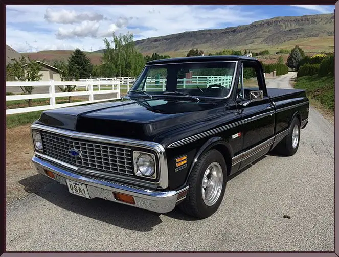 Retro pickup with scenic mountain backdrop