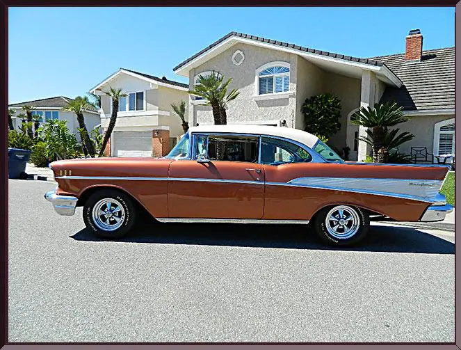 Classic car in front of houses