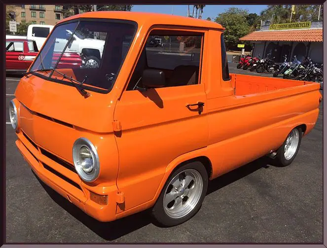 Bright orange pickup in sunny parking lot