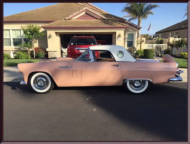 Vintage car with white roof on street
