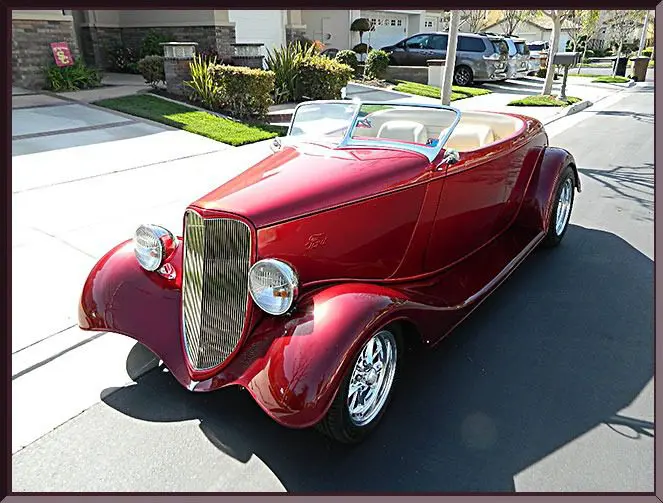 Classic red roadster parked outdoors