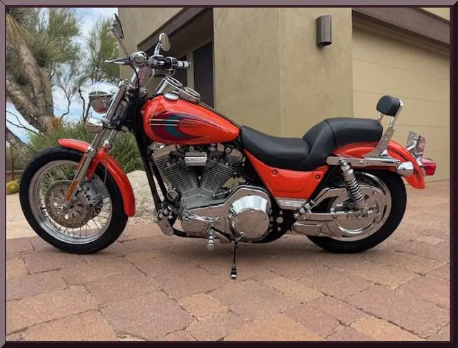 Red motorcycle parked near modern building