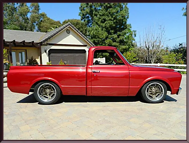 Red vintage pickup truck parked outside house
