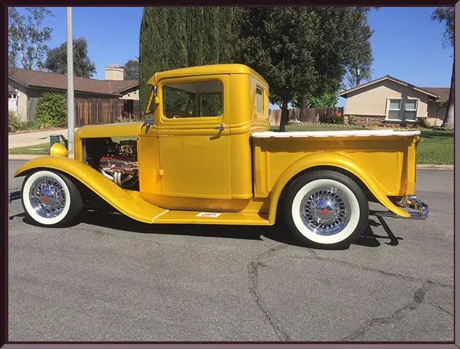 Restored vintage truck with whitewall tires.