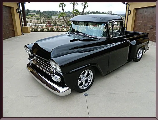 Classic black pickup truck parked outdoors