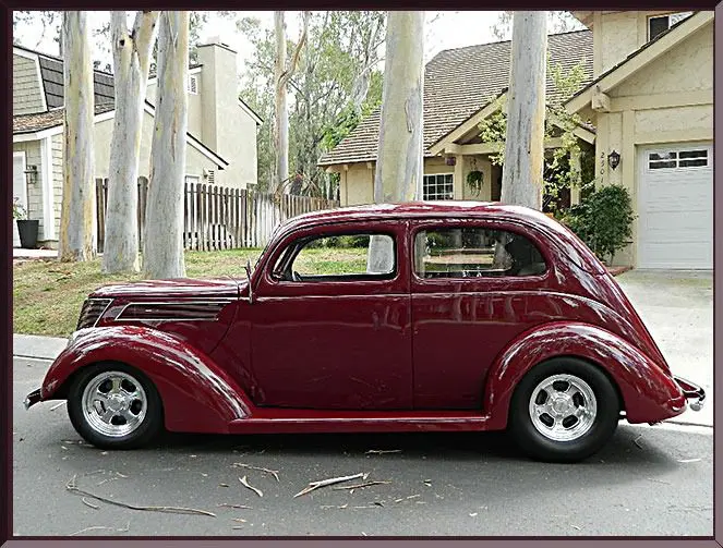 Vintage maroon car parked on street