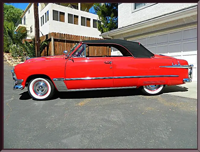 Classic red convertible with black soft top