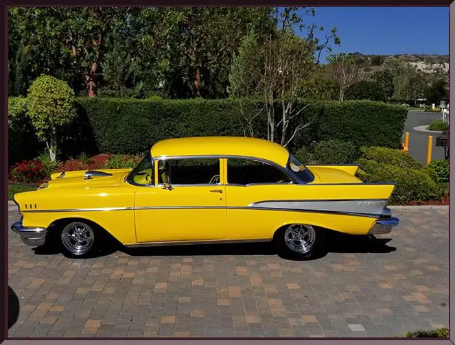 Yellow vintage car parked on driveway