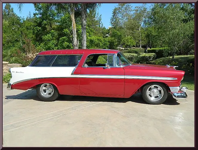 Red and white classic station wagon parked