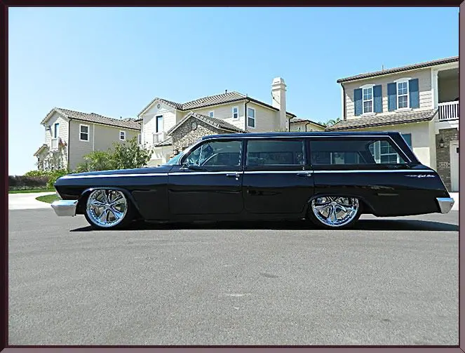 Classic black station wagon on suburban street