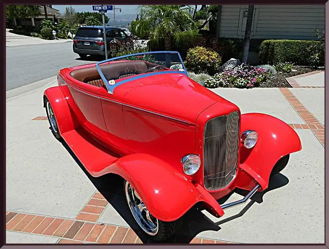 Bright red vintage car on driveway