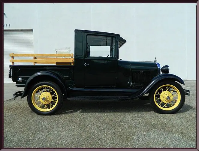 Vintage black truck with yellow wheels