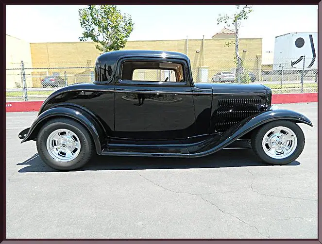 Shiny black retro coupe parked outside