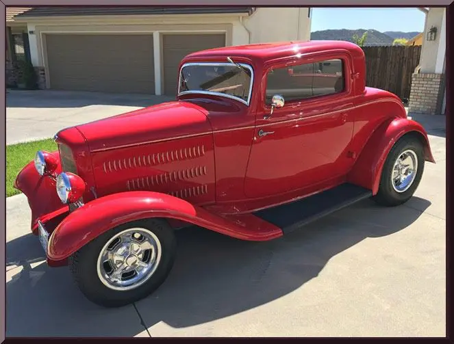 Classic red coupe with chrome wheels