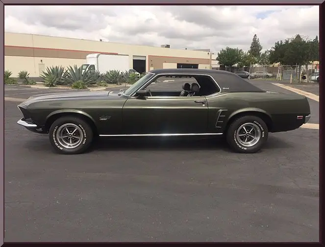 Vintage green muscle car parked outdoors