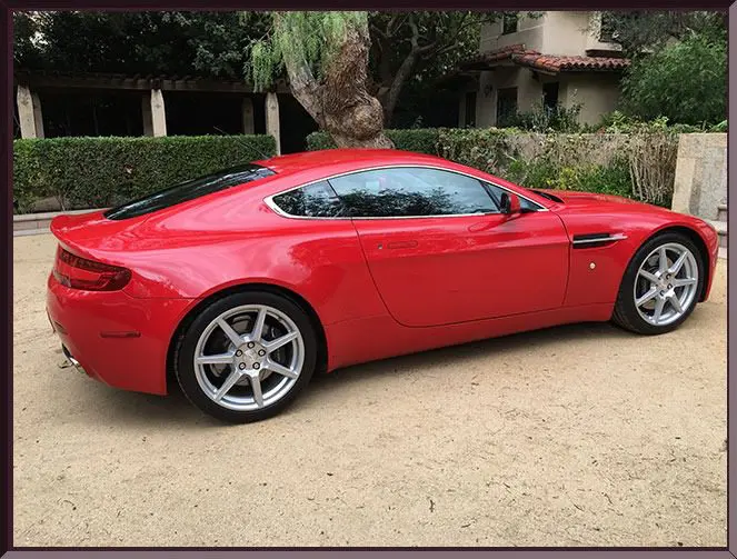 Luxury red coupe outdoors near house