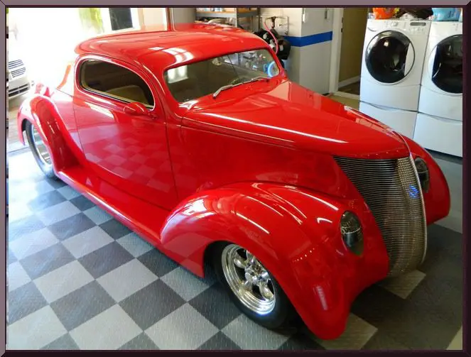 Red vintage car parked in garage
