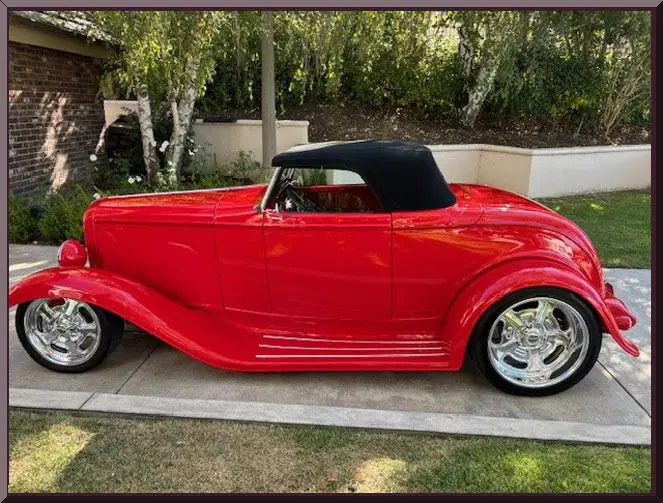 Classic red roadster parked outside