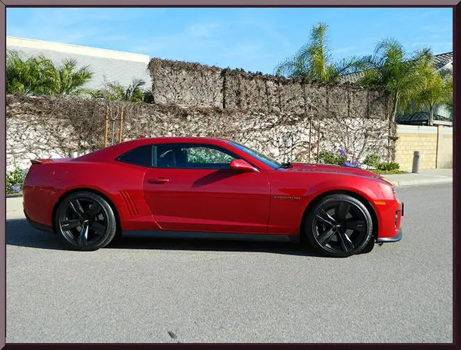 Shiny red sports coupe with black rims