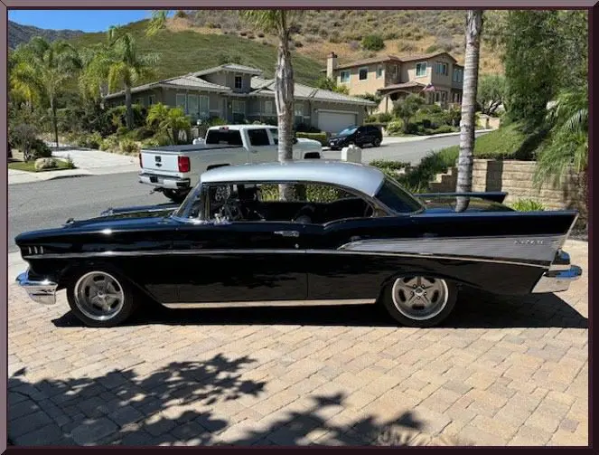 Retro car beside modern houses