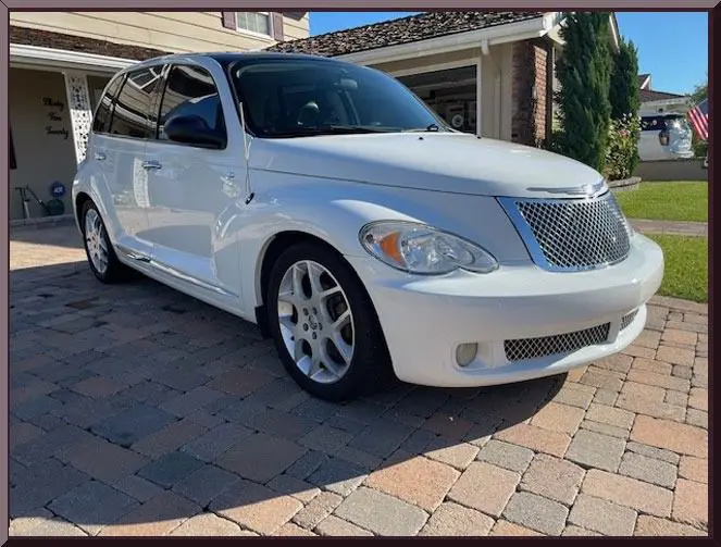 White car parked on brick driveway