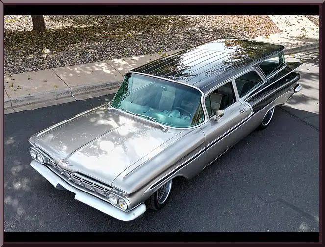 Silver classic 1950s station wagon parked on street