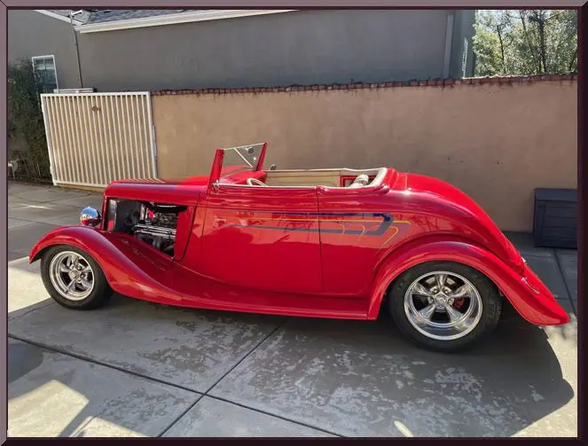 Bright red antique car in driveway